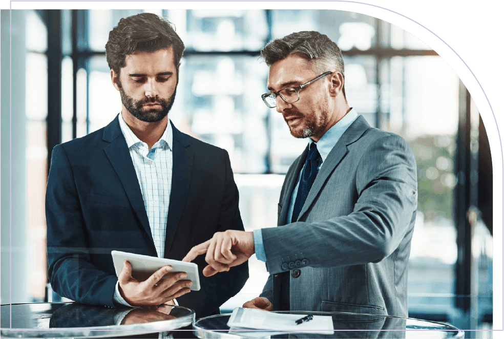 Business professionals reviewing workforce planning data on a tablet
