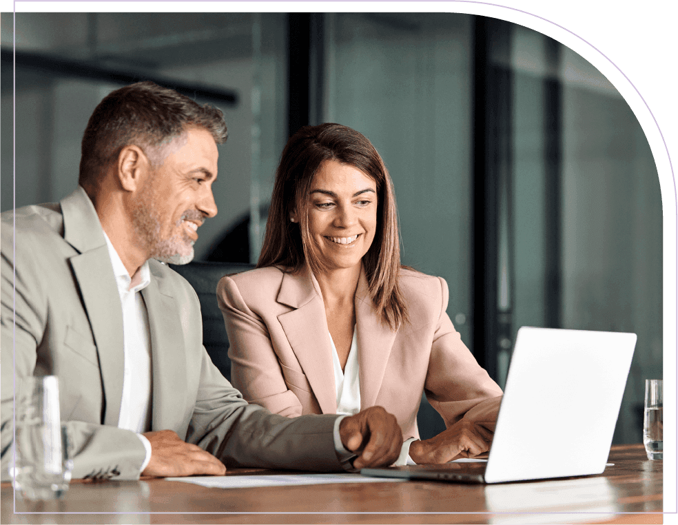 Business professionals reviewing workforce planning information on a laptop