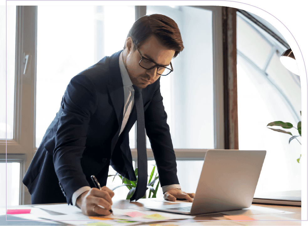Professional reviewing workforce plans and business data on a laptop